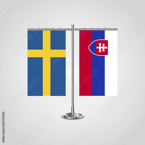 Table stand with flags of Sweden and Slovakia.Two flag. Flag pole. Symbolizing the cooperation between the two countries. Table flags