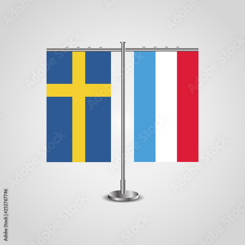 Table stand with flags of Sweden and Luxembourg.Two flag. Flag pole. Symbolizing the cooperation between the two countries. Table flags