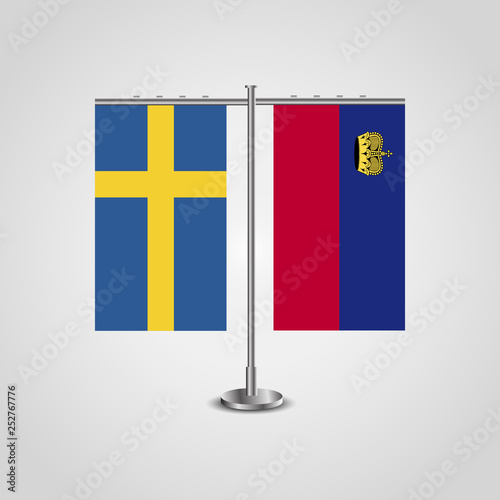 Table stand with flags of Sweden and Liechtenstein.Two flag. Flag pole. Symbolizing the cooperation between the two countries. Table flags