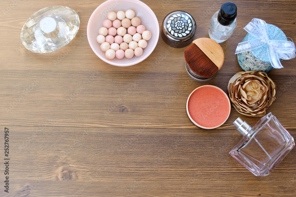 Cosmetics, perfume, cream and candles on wooden background. Female background. Cosmetics, perfume, cream and candles on wooden background. Female background.