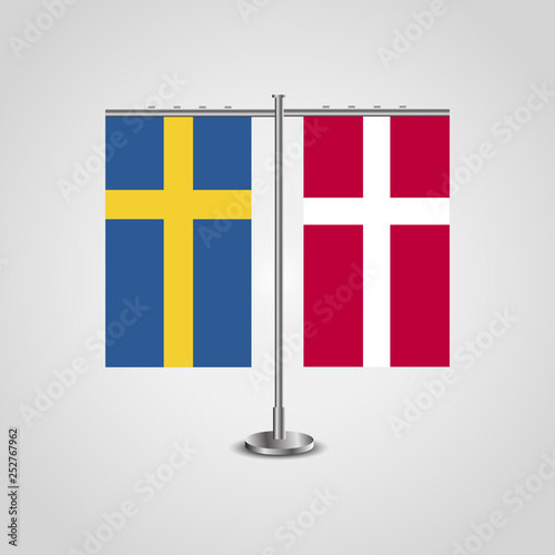 Table stand with flags of Sweden and Denmark.Two flag. Flag pole. Symbolizing the cooperation between the two countries. Table flags