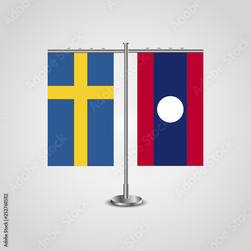 Table stand with flags of Sweden and Laos.Two flag. Flag pole. Symbolizing the cooperation between the two countries. Table flags