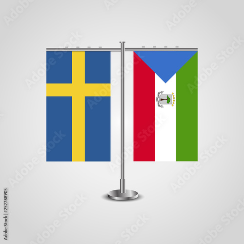 Table stand with flags of Sweden and Equatorial Guinea.Two flag. Flag pole. Symbolizing the cooperation between the two countries. Table flags