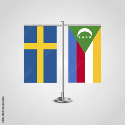 Table stand with flags of Sweden and Comoros.Two flag. Flag pole. Symbolizing the cooperation between the two countries. Table flags