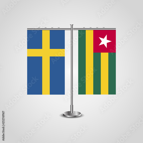 Table stand with flags of Sweden and Togo.Two flag. Flag pole. Symbolizing the cooperation between the two countries. Table flags