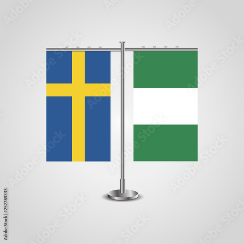 Table stand with flags of Sweden and Nigeria.Two flag. Flag pole. Symbolizing the cooperation between the two countries. Table flags