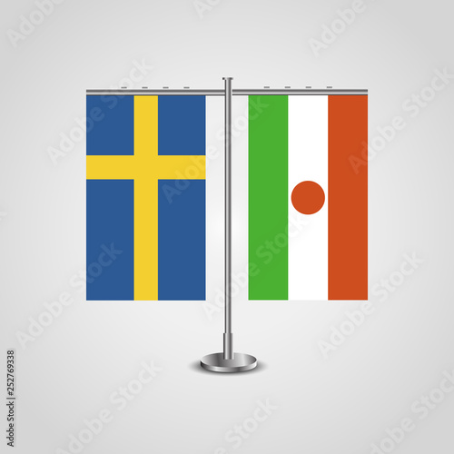 Table stand with flags of Sweden and Niger.Two flag. Flag pole. Symbolizing the cooperation between the two countries. Table flags