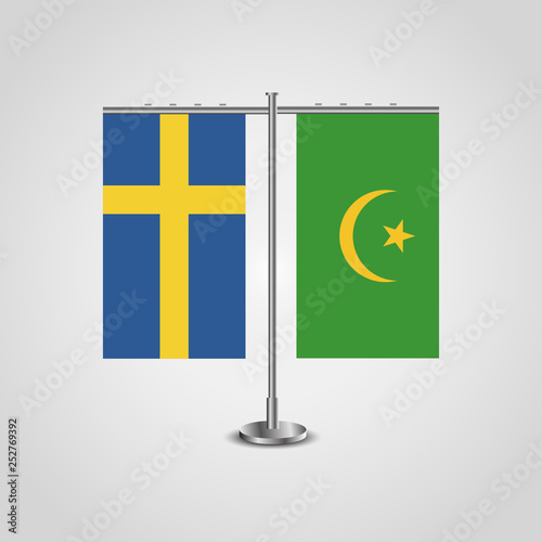 Table stand with flags of Sweden and Mauritania.Two flag. Flag pole. Symbolizing the cooperation between the two countries. Table flags