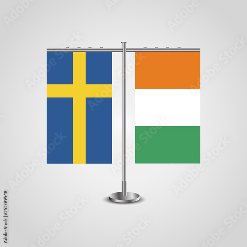 Table stand with flags of Sweden and Côte d'Ivoire.Two flag. Flag pole. Symbolizing the cooperation between the two countries. Table flags