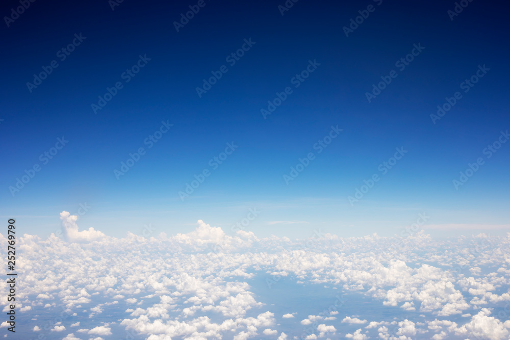 Blue sky background and white clouds soft focus, top view take a picture on airplane.
