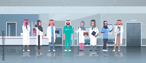 group of arabic doctors team treatment communication concept arab medical hospital mix race workers standing together modern clinic hall interior full length horizontal