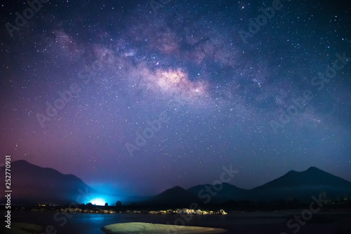 Milky Way galaxy landscape rivers and light with mountains background in the dark night sky