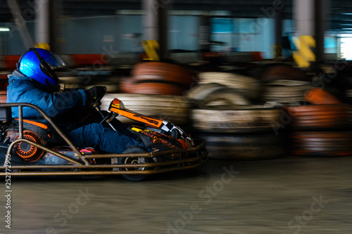 Dynamic karting competition at speed with blurry motion on an equipped racecourse