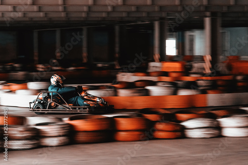 Dynamic karting competition at speed with blurry motion on an equipped racecourse © Niko_Dali