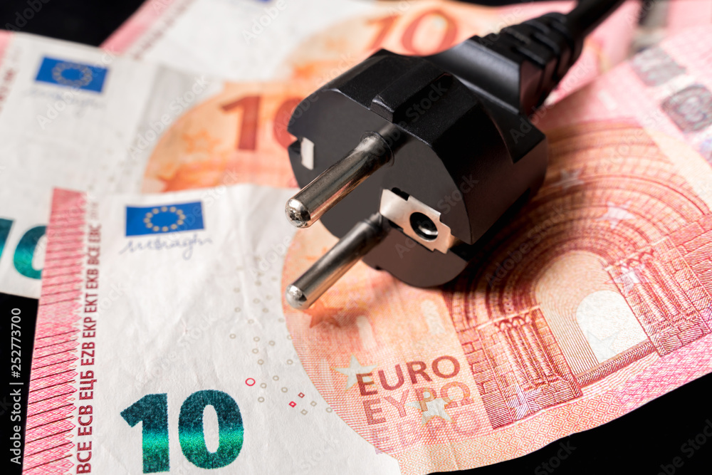 Electric power plug and european money on background Electric power plug and european money on background