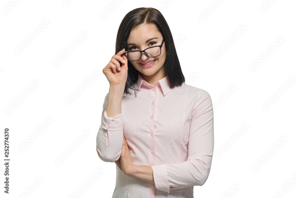 Young confident business woman looking into the camera with lowered glasses on a white isolated background. Young confident business woman looking into the camera with lowered glasses on a white isolated background.