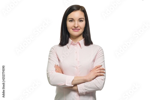 Confident young business woman with crossed arms in pink shirt on white isolated background