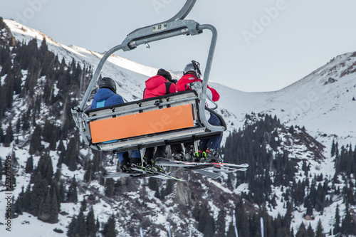 People sitting in the ski lift in Shymbulak ski resort in Kazakhstan