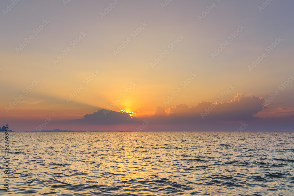 Beautiful dramatic sky clouds with light rays over the sea at sunset time. Natural landscape for background