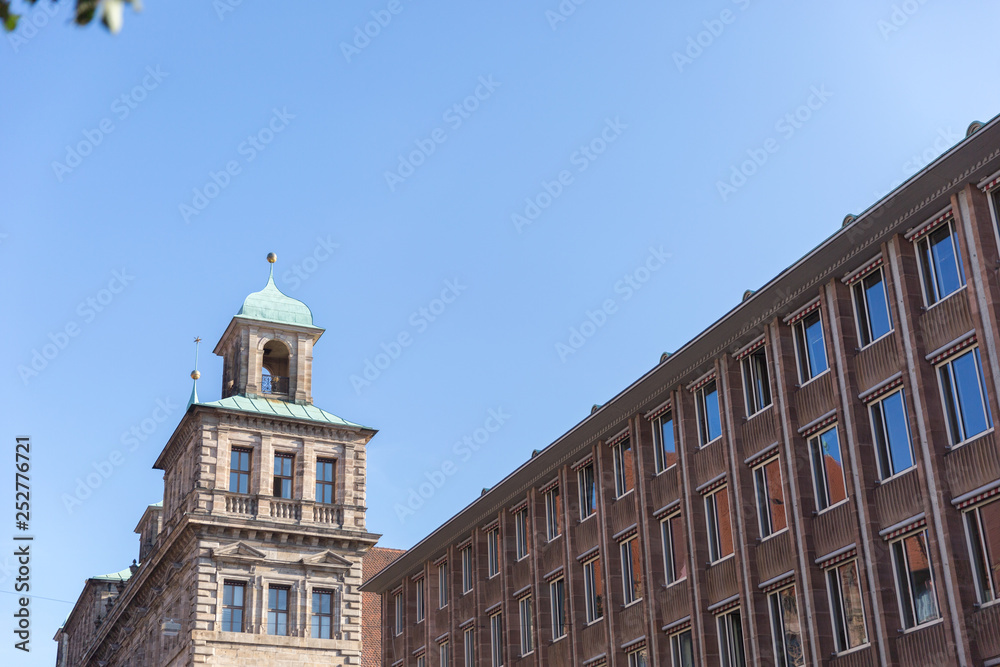 A view of miracolous detailed blue tower of ancient Frauenkirche Church of Our Lady with unusual architecture elements and tall windows  in Nuremberg