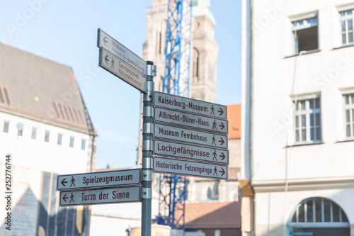 A close up of a road sign in Germany leading to many culture tourist public attractions in Nuremberg © Adamsov studio
