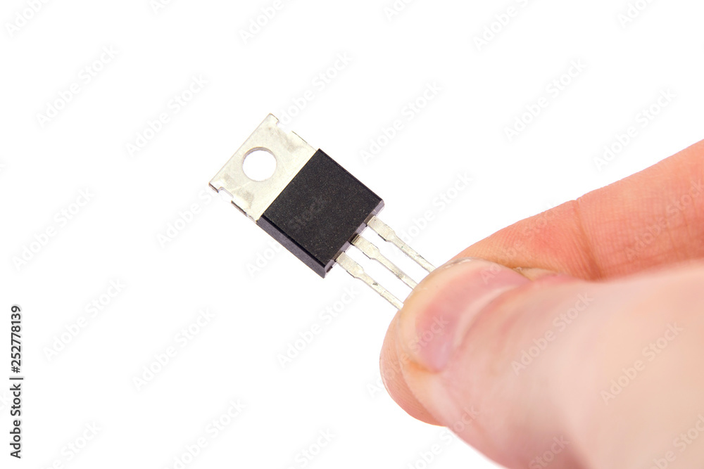 electronic Transistor in hand close-up on white electronic Transistor in hand close-up on white