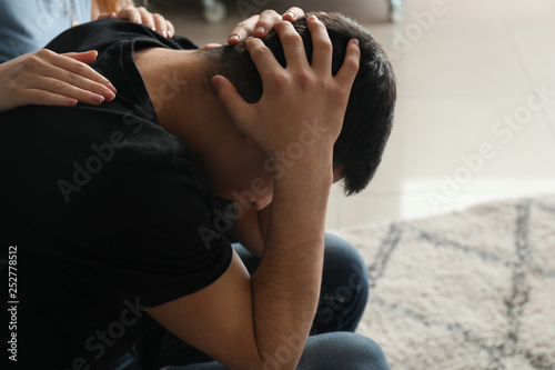 Woman calming depressed mal...