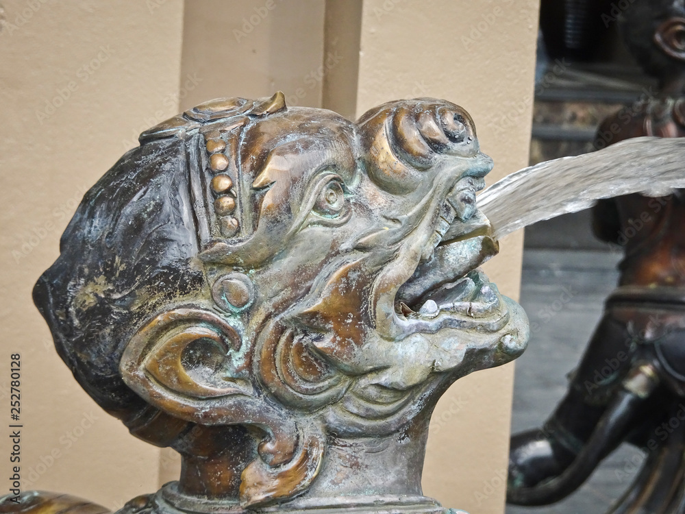 Ao-Nang, THAILAND - December 24, 2018: Sculpture head satyr spews a fountain of water. Ao-Nang, THAILAND - December 24, 2018: Sculpture head satyr spews a fountain of water.