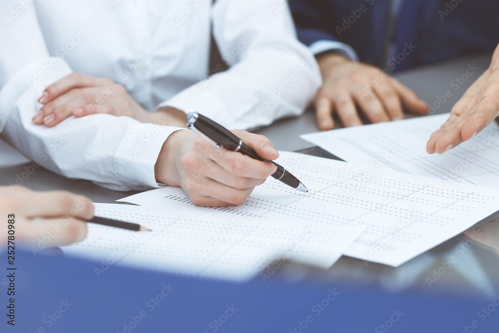 Bookkeepers team or financial inspectors making report, calculating or checking balance. Group of people at work. Business operations concept Bookkeepers team or financial inspectors making report, calculating or checking balance. Group of people at work. Business operations concept