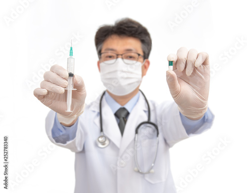 an Asian doctor with medicine in his hands. isolated on white background.