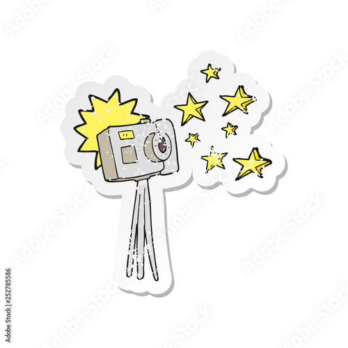 retro distressed sticker of a cartoon camera on tripod with flash