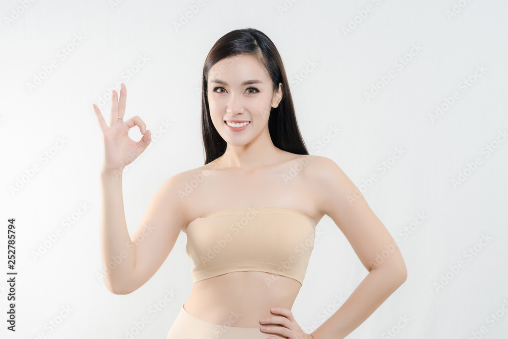 Young cute smiling girl with perfect skin showing OK sign Young cute smiling girl with perfect skin showing OK sign