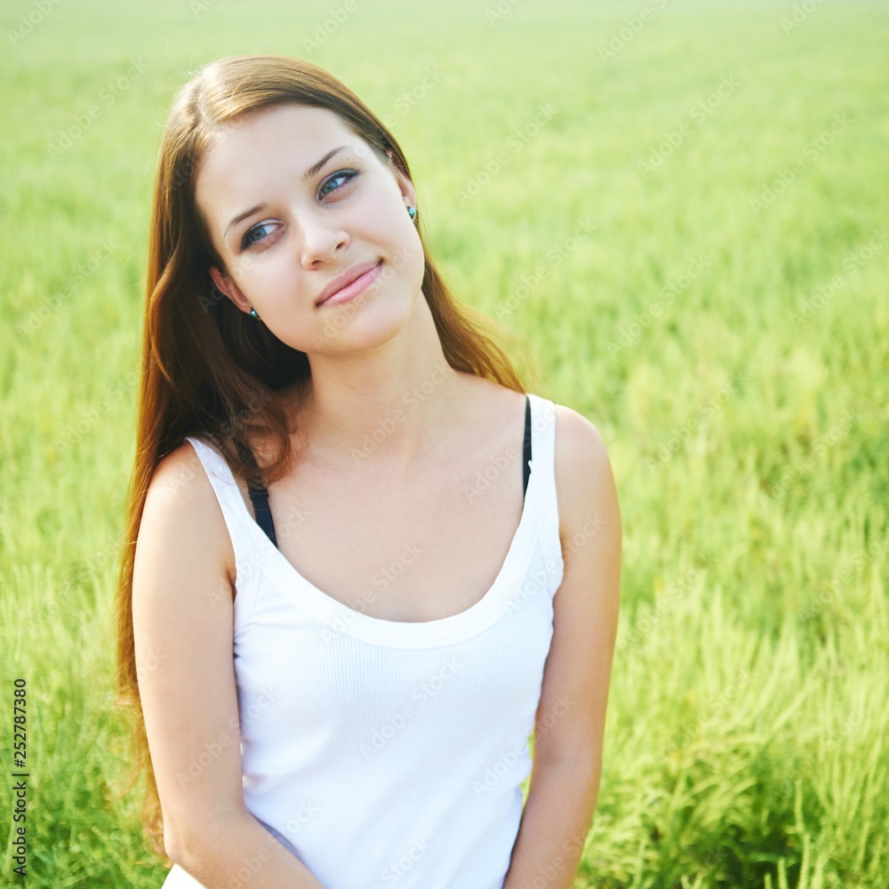 young girl on a background of grass. young girl on a background of grass.