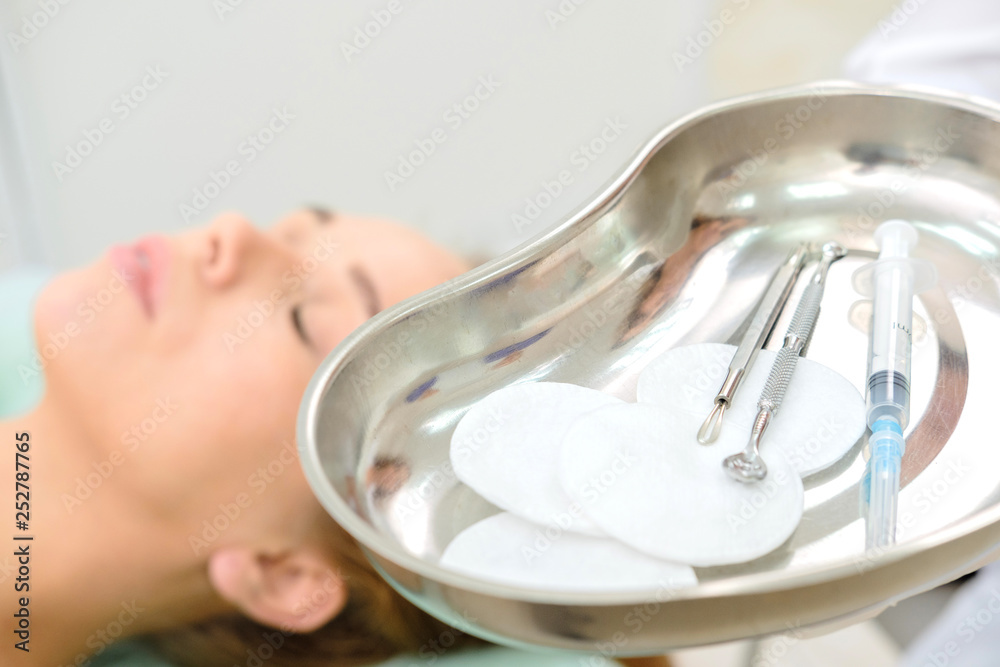 Cosmetologist making mesotherapy and botox injection. Patient and medical tray with sterile syringe. Treatment woman at beautician. Сosmetology, face rejuvenation, beauty salon, plastic surgery clinic