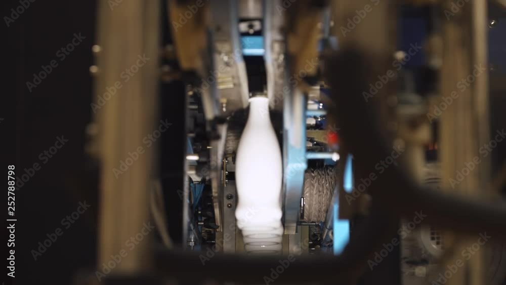 Milk production, white plastic bottles transported on conveyor. Milk production, white plastic bottles transported on conveyor.