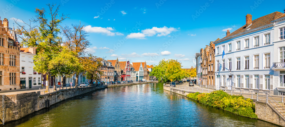 Scenic city view of Bruges with canal. Bright and colorful panorama landscape.