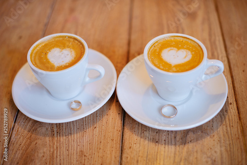 Coffee with wedding rings photo