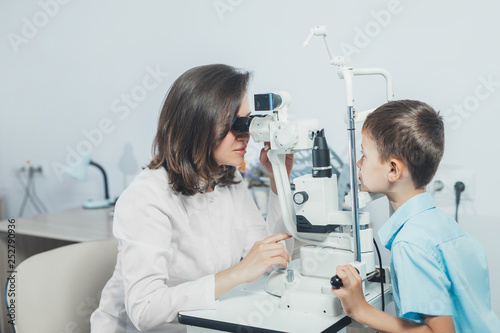 Doctor girlfriend examines eyes child. Hospital, medical examination, diagnosis.