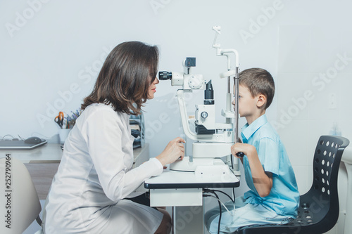 Doctor girlfriend examines eyes child. Hospital, medical examination, diagnosis.