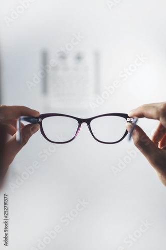 patient is holding glasses for vision. Vision tests at  hospital. focus on  glasses
