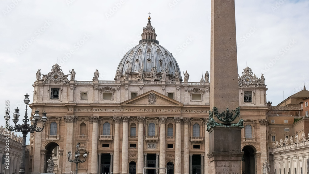 close up of the obelisk and saint peter's basilica, rome