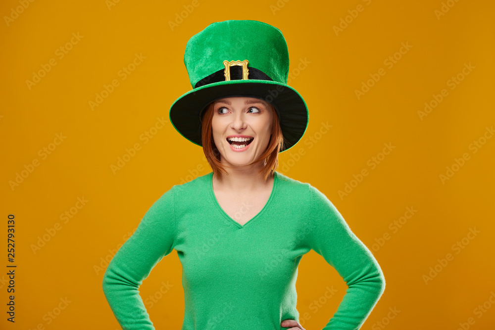 Screaming woman with leprechaun's hat looking at copy space Screaming woman with leprechaun's hat looking at copy space
