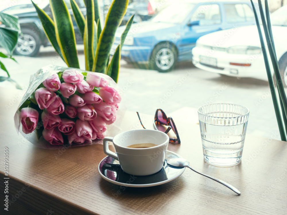 Coffee and spring flowers on coffee shop. Good mood concept. StockFoto