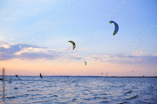people swim in the sea on a kiteboard or kitesurfing