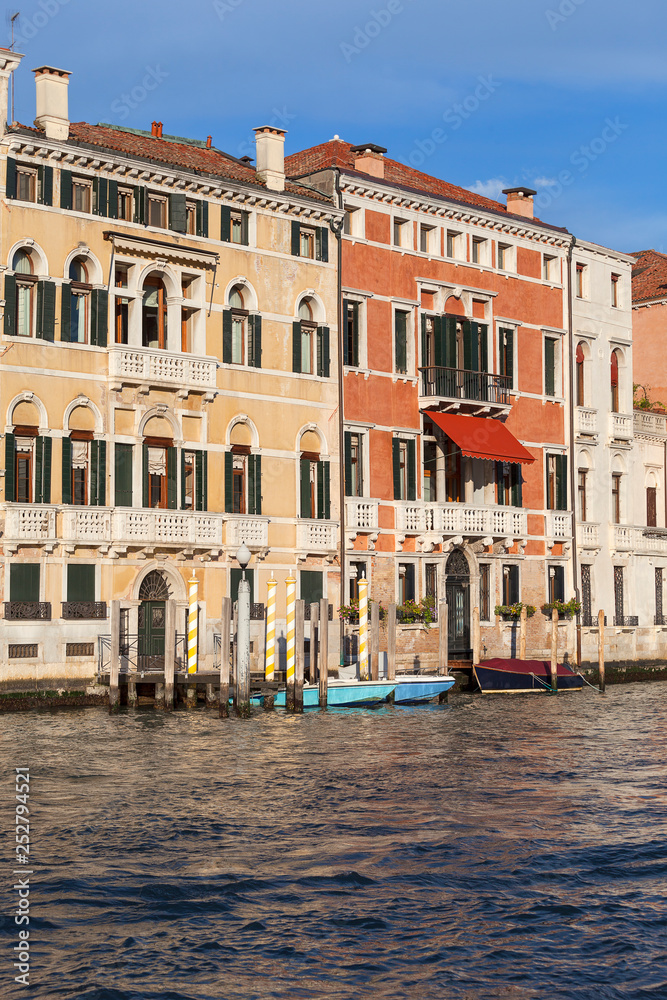 Grand Canal, vintage buildings, parked boats at the marina, Venice, Italy