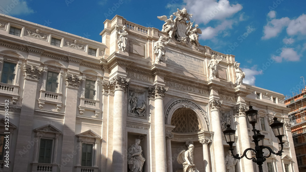 close up view of the top of the facade at trevi fountain, rome,