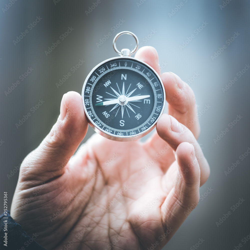 Compass holding in the hand, outdoor adventure Compass holding in the hand, outdoor adventure