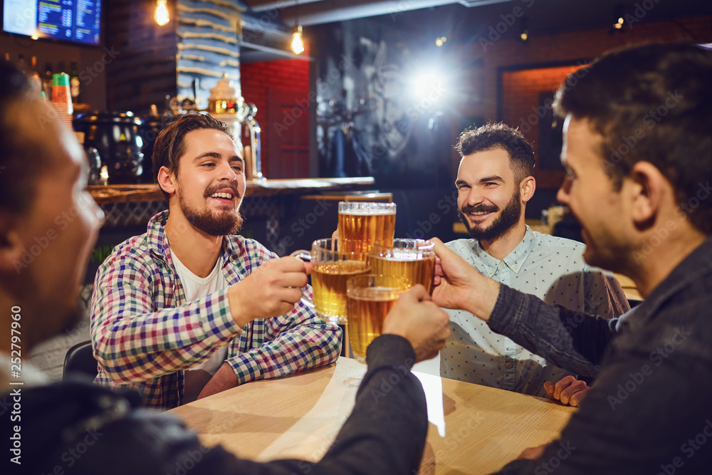 Friends talk, drink beer in a bar. Friends talk, drink beer in a bar.