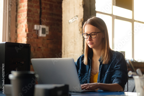 A girl works at a computer in a modern office