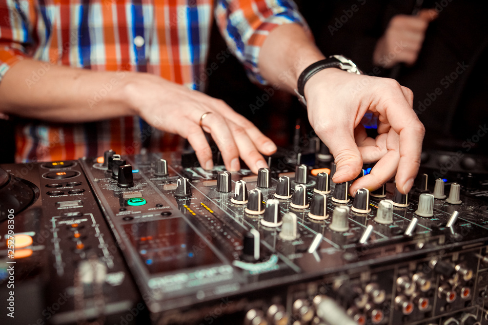 Dj mixes the track in nightclub at party Dj mixes the track in nightclub at party